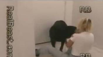 Blond-haired beauty gets banged by a black dog