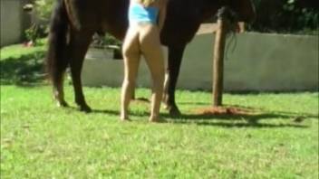 Golden-haired stunner shares passionate moments beside her steed