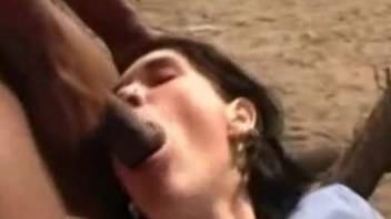 Skinny brunette getting fucked by a dog with her legs spread
