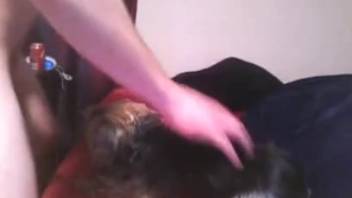 Man pounding his dog's mouth in a bestiality oral video
