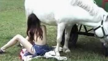 Redhead bitch is sucking her pony and getting fucked in XXX ZOO vid