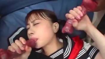 Sexy Japanese babe handling two canine dicks at the same time