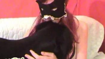 Mask-wearing hottie teasing her small dog on camera
